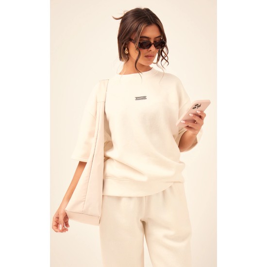PRETTYLITTLETHING Cream Badge Detail Oversized Short Sleeve Sweatshirt PRETTYLITTLETHING Cream Badge Detail Oversized Short Sleeve Sweatshirt